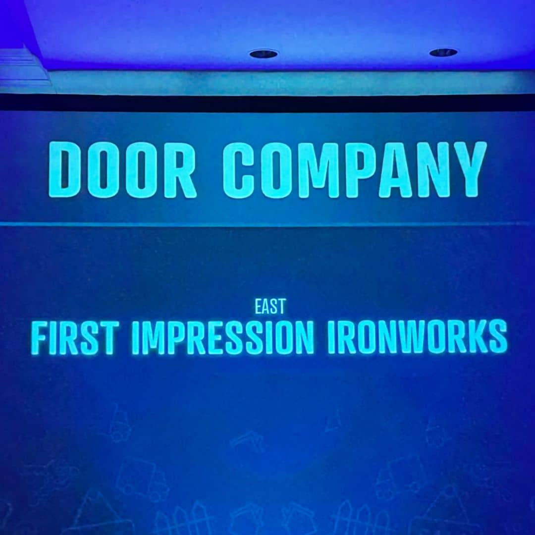 Projection on the wall showing First Impression Ironworks as the winner of the Best Door Company at the Best of the Desert Awards Ceremony